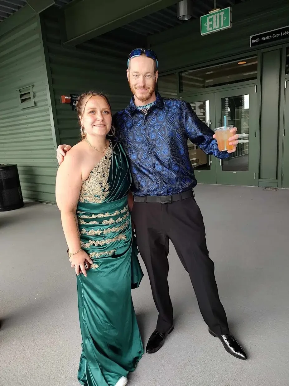 client wearing an emerald formal gown